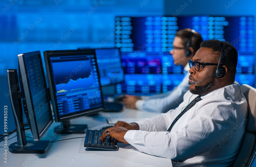 Team of brokers is working in office using workstation and analysis technology. Workplace of professional traders. Global financial markets, business, currency exchange and banking concepts. Team of brokers is working in office using workstation and analysis technology. Workplace of professional traders. Global financial markets, business, currency exchange and banking concepts.