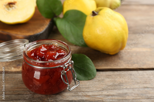 Delicious quince jam on wooden table, closeup
