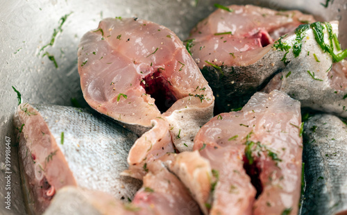 Close up of sliced raw fish pieces marinated with herbs and spices.