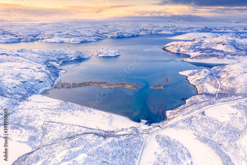 Aerial view of Norwegian County Road 98 along snowy mountains above Laksefjorden, Lebesby, Kunes, Troms og Finnmark, Arctic photo
