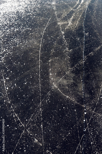background of the surface of patterned black ice of a frozen lake