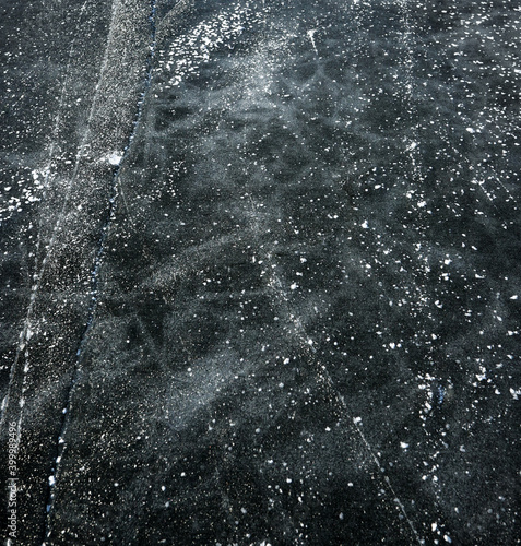 background of the surface of patterned black ice of a frozen lake