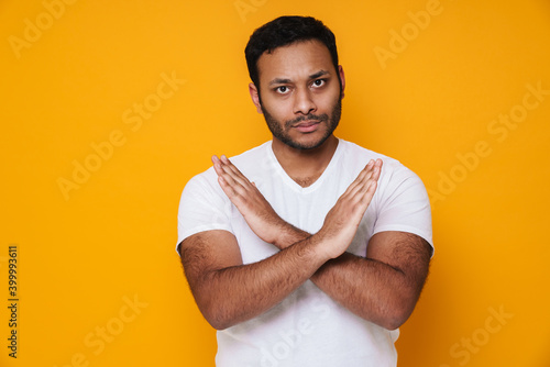 Asian brunette unshaven serious man crossing his arms