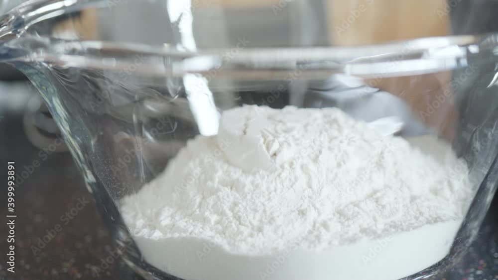 Preparing homemade waffle batter in glass mixing bowl to make fresh waffles for breakfast. Preparing homemade waffle batter in glass mixing bowl to make fresh waffles for breakfast.