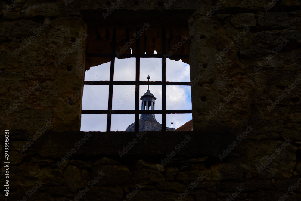 view of the spire in the window with bars