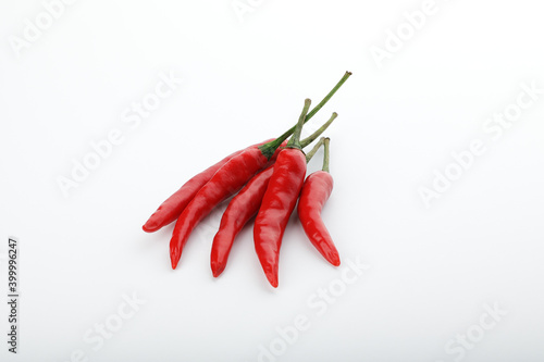 five chili peppers on gray background with shadow
