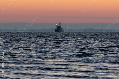 a ship on the sea at sunrise © Ingo