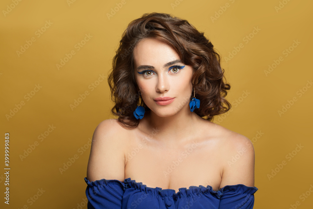 Attractive model woman with perfect curly hair on yellow background Attractive model woman with perfect curly hair on yellow background