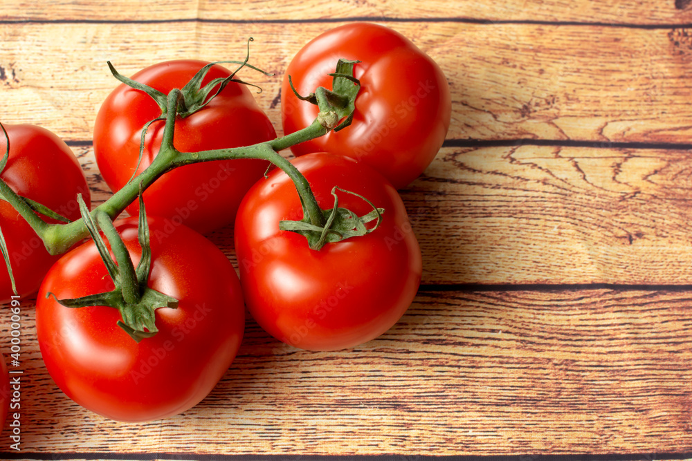 large red tomatoes on a branch close-up large red tomatoes on a branch close-up