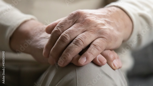 Fototapeta Naklejka Na Ścianę i Meble -  Time teaches us patience. Close up view of older generation male palms joined on his lap. Problems of retired people. Health failing with age. Patronage and psychological support for elderly persons