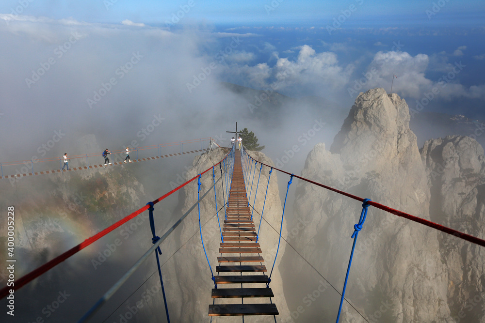 Φωτογραφία Steps of a suspension bridge near a cliff in the fog in the Ai-Petri mountains i