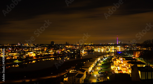 Night view over Dortmund in the "Ruhrgebiet" area with a lake in the front and the tv tower in the background