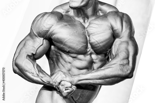 Bodybuilder athlete torso. Black and white photo.
