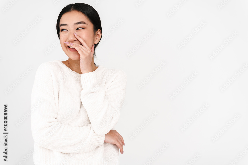 Asian cheerful nice girl laughing and covering her mouth Asian cheerful nice girl laughing and covering her mouth