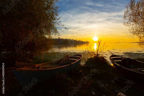 Beautiful sunset landscape at Gölyazı (Golyazi) on Lake Ulubat. with golden sun and tree, Bursa, Turkey. photo