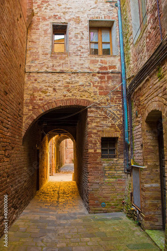 A quiet residential back street in the historic medieval village of Buonconvento  Siena Province  Tuscany  Italy 