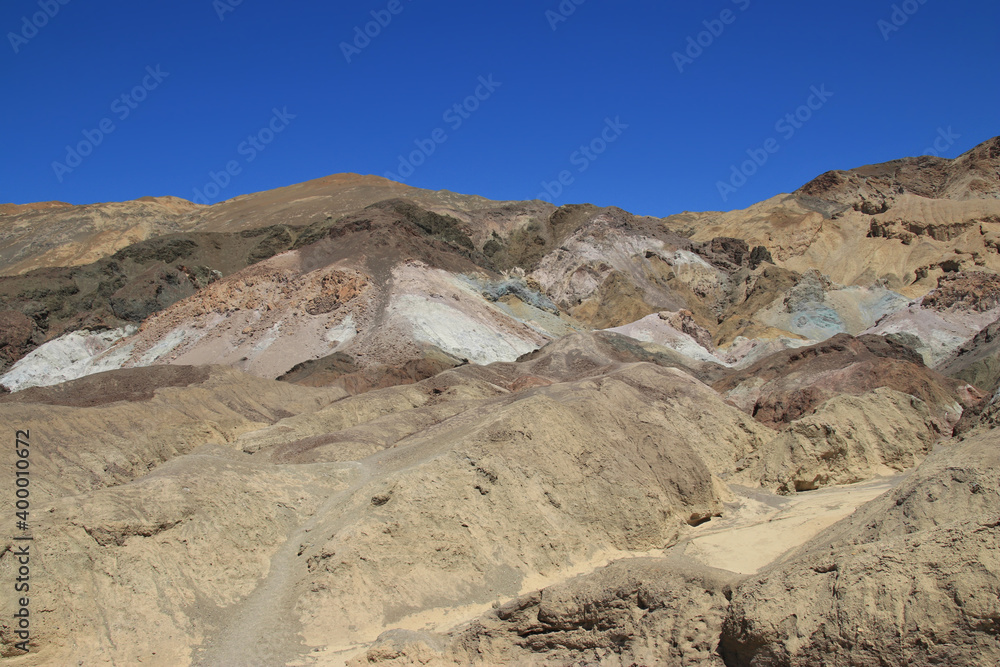 different stones in Death valley national park in front of a cloudless blue sky