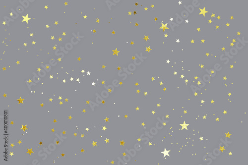 Gray background with shiny golden glitter on it. Dots, stars and little sparkles in flat lay stile. Festive concept.