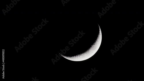 Waxing crescent moon slowly setting.  Close up. photo