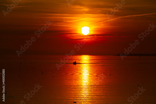 Beautiful sunset landscape at Gölyazı (Golyazi) on Lake Ulubat. with golden sun and tree, Bursa, Turkey. photo