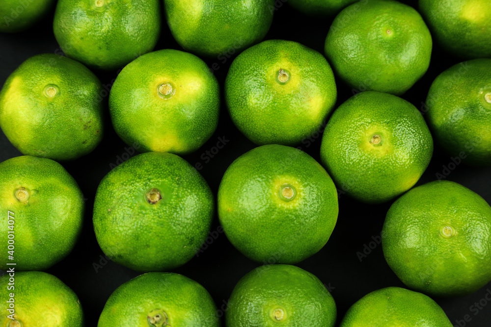 Green sweet tangerines growing with background Green sweet tangerines growing with background
