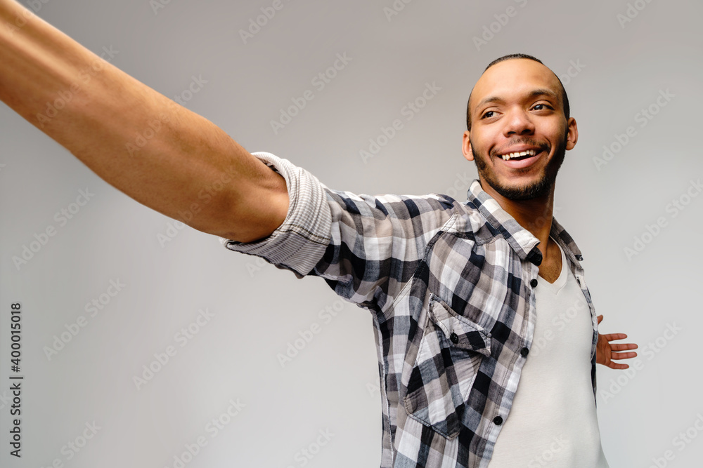 Naklejka premium Happy african american man using mobile phone for video call