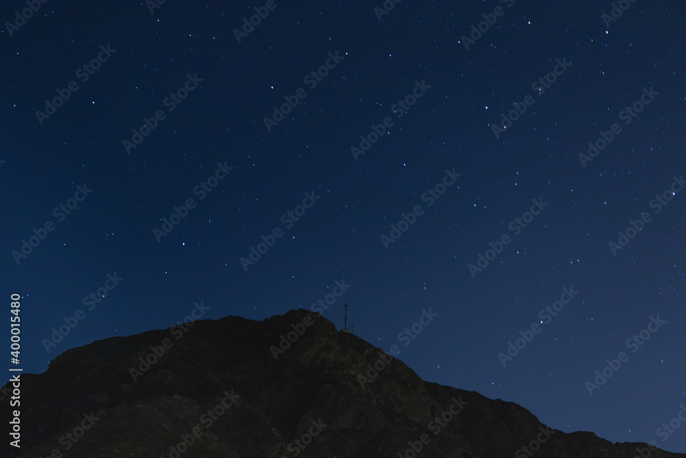 horizontal landscape at night with blue sky full of stars and rocky mountains, Lima Peru