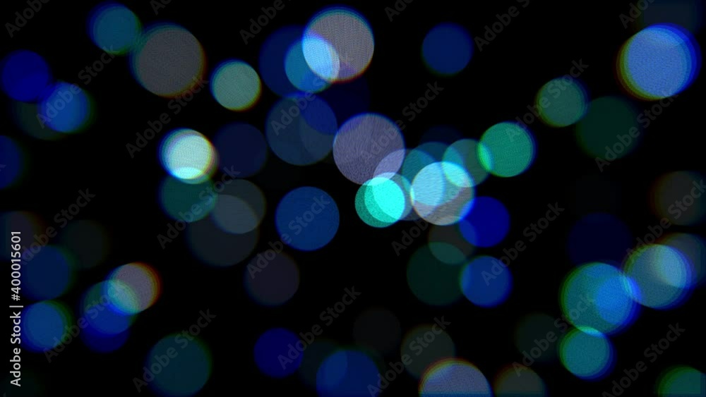 Glowing multicolored lights on a black background. Bokeh effect. Glowing multicolored lights on a black background. Bokeh effect.
