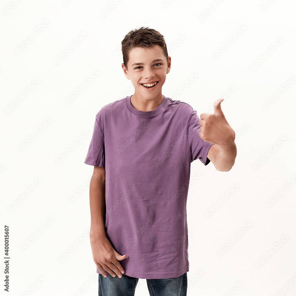 Happy teenaged disabled boy with cerebral palsy smiling and showing thumbs up at camera, posing isolated over white background Happy teenaged disabled boy with cerebral palsy smiling and showing thumbs up at camera, posing isolated over white background