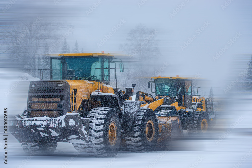 blurred view of big excavators at worksite blurred view of big excavators at worksite