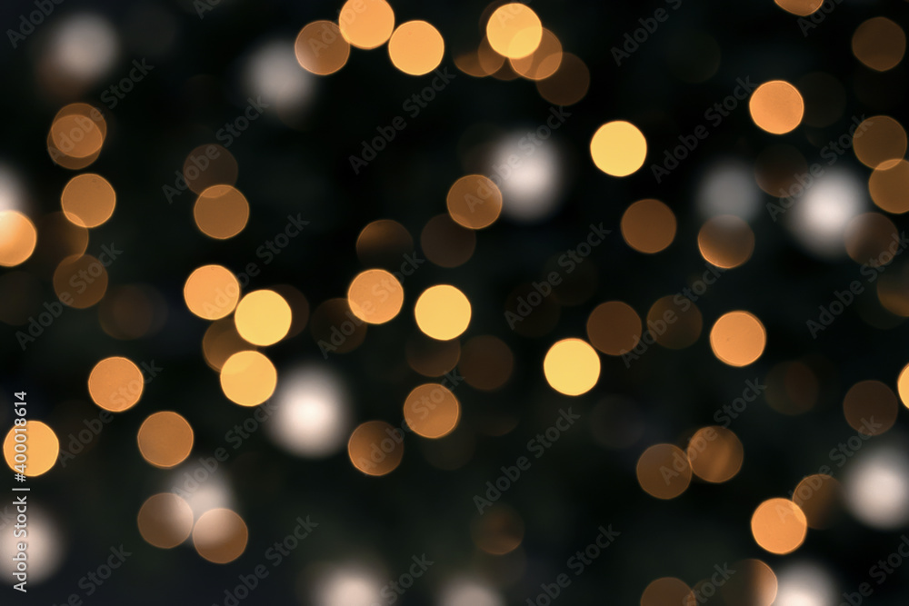 Gold bokeh on a black background. New year festive background Gold bokeh on a black background. New year festive background