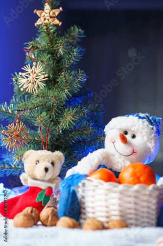 Christmas and New Year mood. Christmas tree. Tangerines, nuts, Christmas toys and lights.