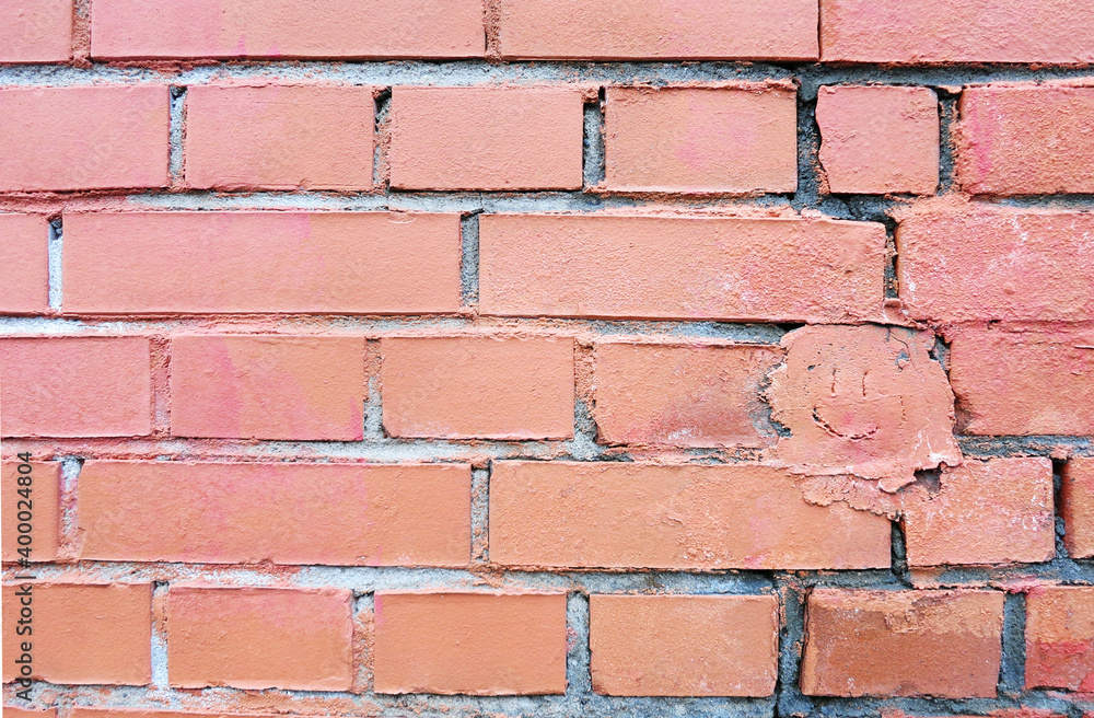 Obraz premium Masonry background with face on the wall