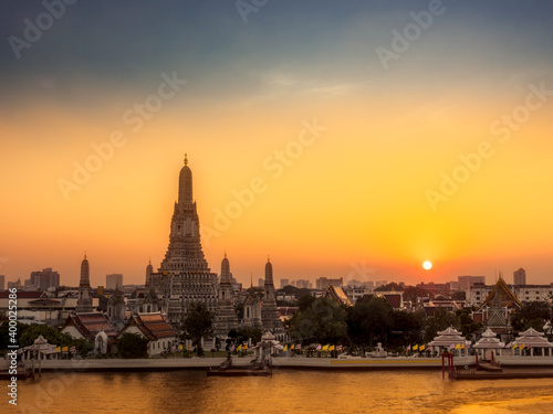 View of Wat Arun and Chao Phraya river at sunset. Buddhist Temple and Landmarks in Bangkok Thailand © thanmano