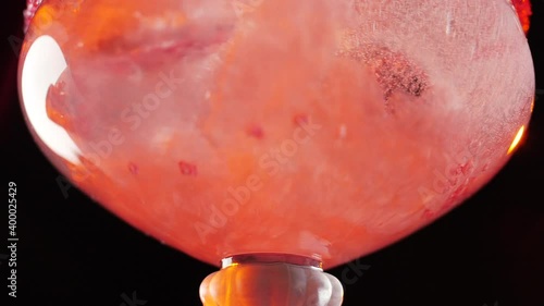 Liquid pouring into a cocktail glass in extreme slow-motion. 180 fps. High quality FullHD footage photo