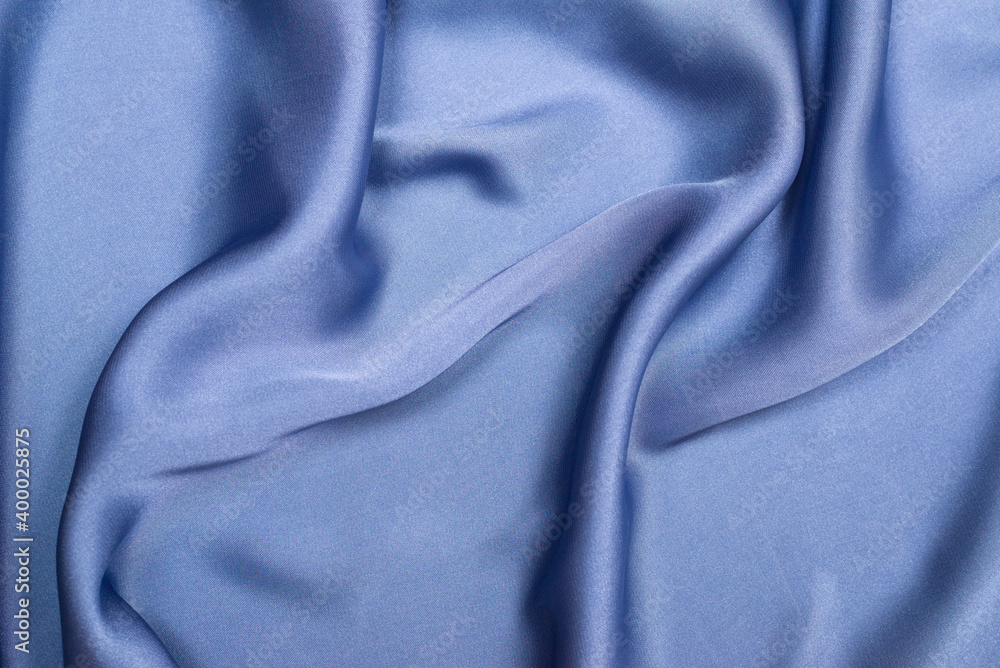 Blue silk or satin luxury fabric texture. Top view. Blue silk or satin luxury fabric texture. Top view.