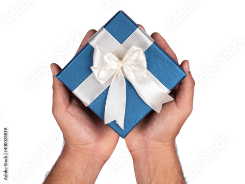 person holding a blue gift box with white ribbon on isolated white background