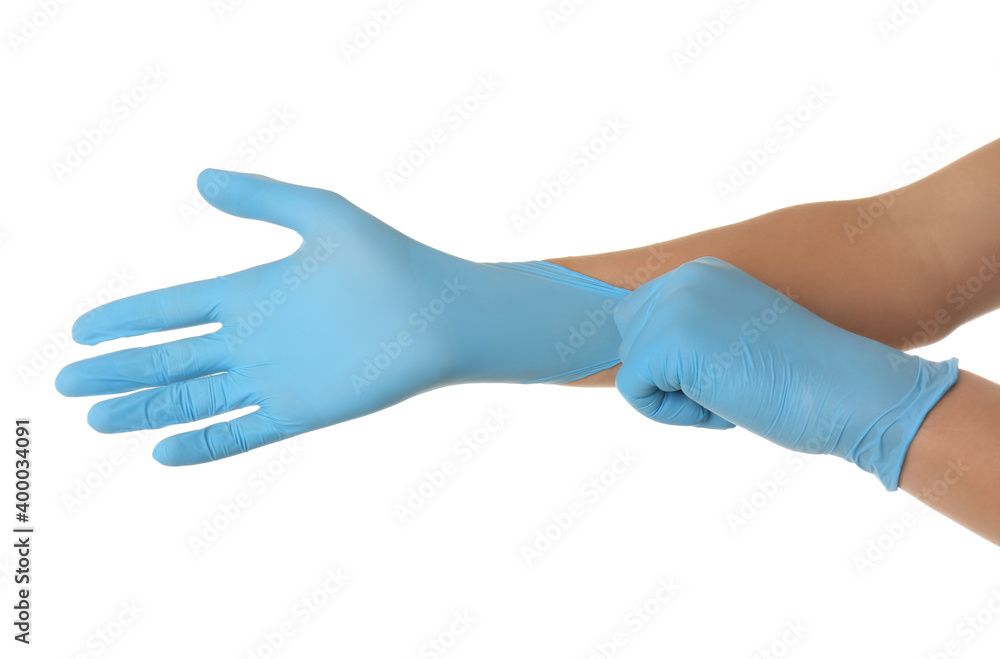 Person putting on blue latex gloves against white background, closeup