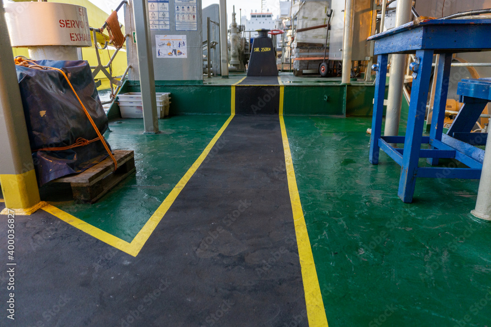 Safety walkway on ships deck. Yellow black anti-slip safety walkway for ships crew and contractors. Passengers or contractors footpath on board offshore vessel. Safety walkway on ships deck. Yellow black anti-slip safety walkway for ships crew and contractors. Passengers or contractors footpath on board offshore vessel.