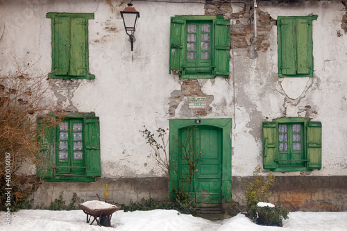 Bild auf Leinwand Horizontal shot of an old mountain house façade with its wooden gate and windows