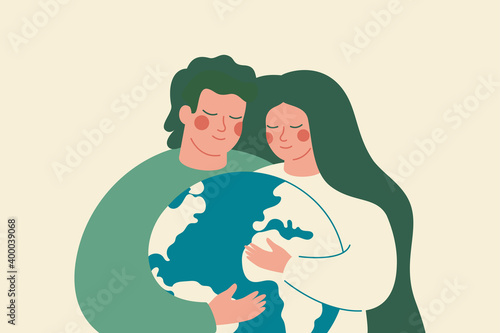 Young woman and man embrace green planet Earth with care and love. Family support the Environment conservation and energy-saving concept.
