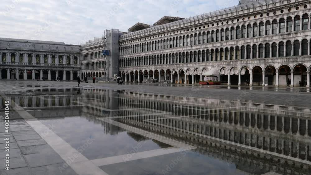 Venice, Italy - December 2020 - San Marco square, monuments reflected on the high water Venice, Italy - December 2020 - San Marco square, monuments reflected on the high water