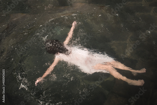 Ritual and beliefs: girl floating and cleansing in water  photo