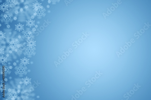 Pastel blue Christmas background with snowflakes, copy space