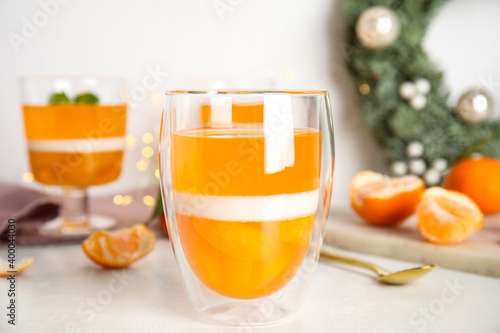 Delicious tangerine jelly in glass on white table