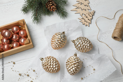 Flat lay composition with beautiful Christmas baubles on white wooden table