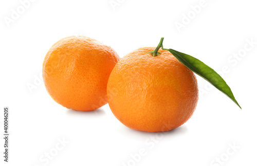 Whole fresh tangerines with green leaf on white background