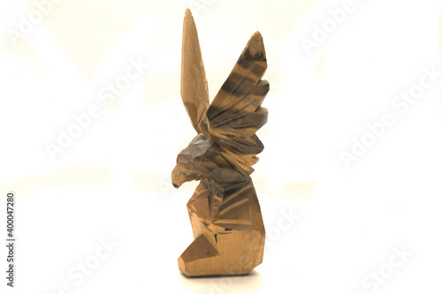 wooden figurine of an eagle on a white background