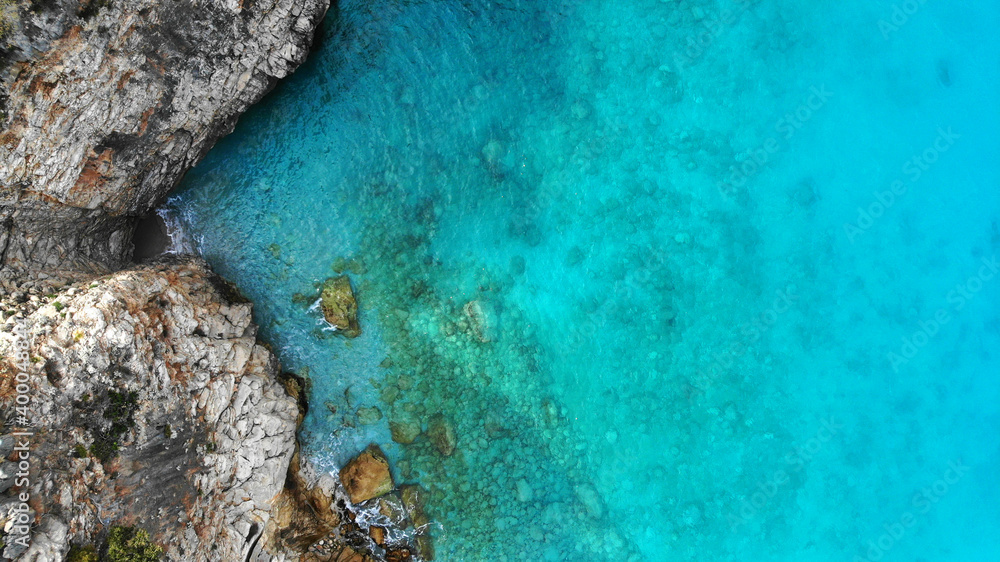 Aerial. Sea water and shore rocks texture background. Top view from drone. Aerial. Sea water and shore rocks texture background. Top view from drone.