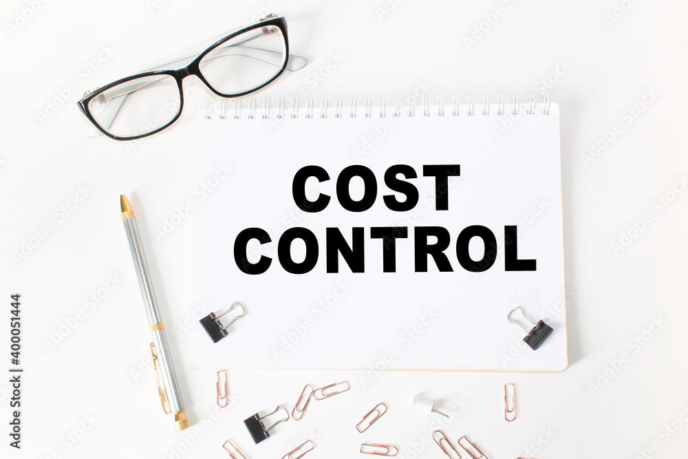 Notepad with inscriptions COST CONTROL on a white background. business concept. Notepad with inscriptions COST CONTROL on a white background. business concept.